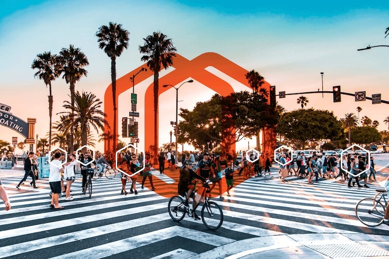 Group of people walking and riding bikes on crosswalk